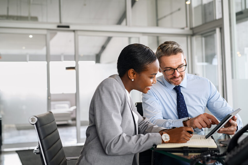 business partners working on digital tablet in modern office