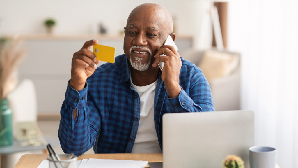 Senior African man makes secure contact center payment