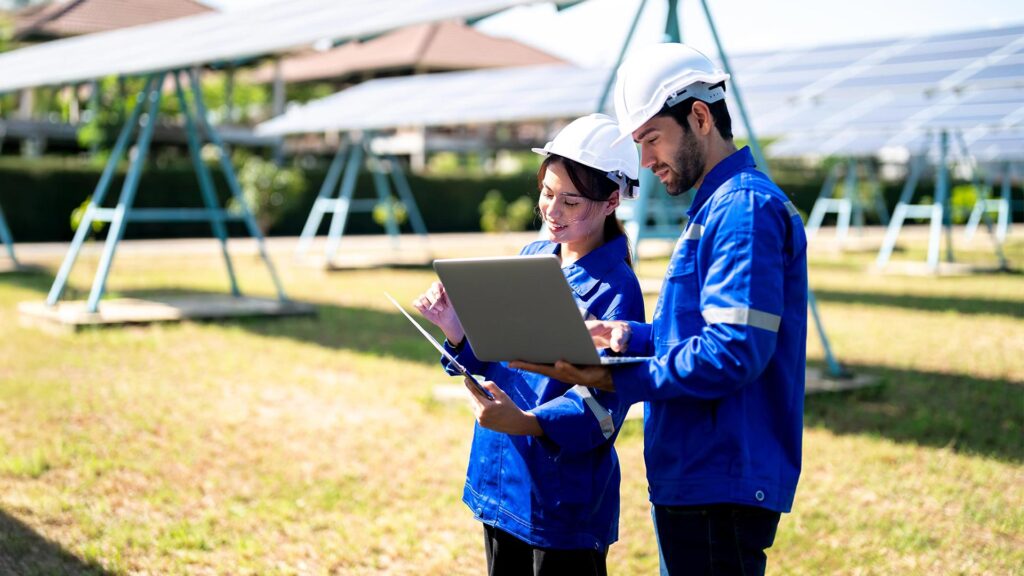 Utility workers in a solar panel field